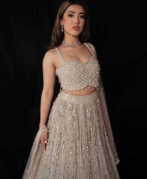 Contemporary cuts for the modern Indian woman best sums up the @seema.m.official⁠ aesthetic. 🔗 TAP LINK IN BIO to see more from this designer⁠ Outfit: @seema.m.official⁠ Makeup: @ammara.artistry Hair: @stylesbysukhi Jewellery: @reddotjewels Photography: @qaiserazim #lehenga #bridalwear #indianbride White And Grey Makeup, White Lehenga Makeup Look, Engagement Outfits Indian, Indian Wedding Dress Modern, Luxury Indian Wedding, Official Makeup, Lehenga Bridesmaid, Reception Outfits, Indian Wedding Lehenga