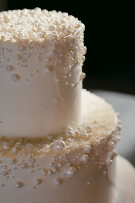 white wedding cake covered in pearls Wedding Cake Pearls Elegant, Pearl Cake Topper, Wedding Cake All White, Wedding Cake Pearl, White Cake Wedding, All White Cake, Pearl Wedding Cake, Elegant Wedding Cake Toppers, Monochromatic Wedding