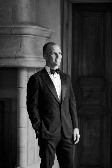 Black-and-white portrait of the groom in a black suit, white shirt, and black bow tie, exuding timeless elegance at Château de Fontarèches. Black Suit White Shirt, Countryside Style, Modern Suits, Classic Tuxedo, Groom Ties, Suit White, French Elegance, Chateau Wedding, Wedding List