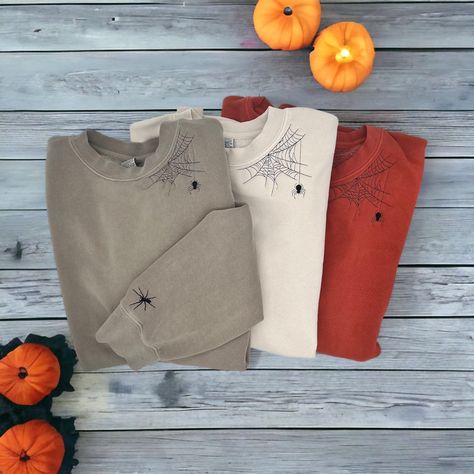 Are you ready for Spooky Season? Get ready with this embroidered spiderweb crewneck. Included with a crawly spider friend on your wrist to keep you company while you drink your coffee or watch your favorite scary movies.  **Color shown is Pigment Cement** ORDERING & SHIPPING *Your item will be shipped within 5-7 business days. *Please allow 2-5 business days to receive your item, more time may be necessary depending on holidays. *We do not accept returns/refunds but please reach out with any con Embroidery Halloween Sweatshirt, Embroidered Halloween Sweatshirt, Halloween Embroidery Sweatshirt, Embroidered Wildflowers, Hand Embroidered Sweatshirt, Spooky Sweatshirt, Halloween Embroidery, Halloween Sweater, Sweatshirt Halloween