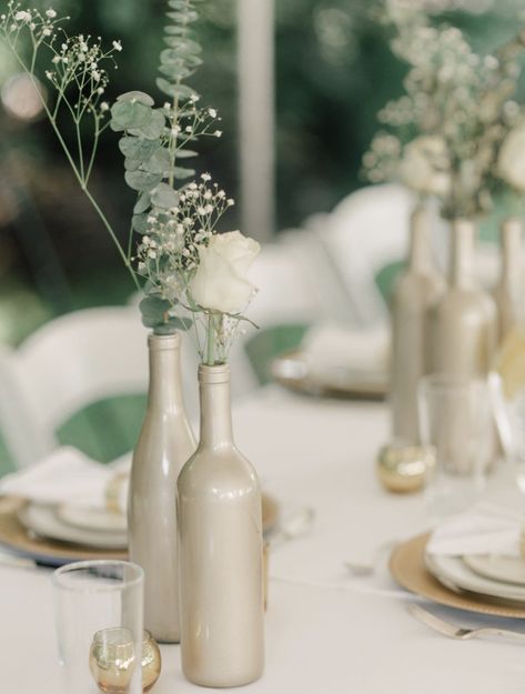 70+ DIY Wedding Decorations With Big-Budget Looks Gold Wine Bottle Centerpiece, Wedding Bottle Decorations, Wine Bottle Centerpiece, Wine Bottle Wedding Centerpieces, Wine Bottle Centerpieces, Wedding Wine Bottles, Gold Wine, Bottle Centerpieces, Simple Wedding Centerpieces