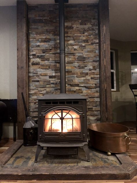 Wood Stove With Chimney, Wood Burning Stove Cabin, Galvanized Tin Walls Fireplace, Farmhouse Wood Stove Surround, Diy Woodstove Surrounds, Woodstove Backdrop Ideas, Pellet Stove With Stone Wall, Wood Stove Placement, Wood Stove Between Windows