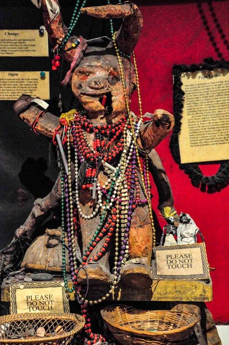 The pin is a photo of a small clay figurine smoking a pipe and covered in colourful bead necklaces. The figurine is that of the voodoo god Papa La Bas and is in a voodoo museum in New Orleans. Voodoo Aesthetic, Louisiana Voodoo, New Orleans Itinerary, Voodoo Art, Lafayette Cemetery, Battle Of New Orleans, New Orleans Voodoo, Marie Laveau, Papa Legba