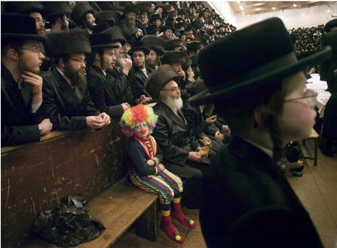 A child dressed as a clown participates with other ultra-Orthodox Jewish men in the Purim festival at a synagogue in Jerusalem. Purim Festival, Krusty The Clown, Image Meme, Official Dresses, Jewish Festivals, Jewish Men, Send In The Clowns, Clowning Around, Clown Costume