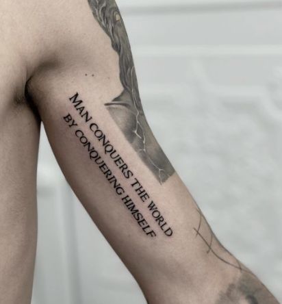 The Man Conquers Tattoo Quotes For Guys Tattoo Ideas For Men Arm Meaningful, Tattoo Designs Men Quote, Back Tattoo Writing Man, Quotes For Tattoos For Guys, Tattoo Ideas Men Meaningful Arm Sleeve, Mens Quote Tattoos, Small Text Tattoo Men, Meaningful Tattoo Quotes For Men, Quotes Deep Meaningful Tattoo