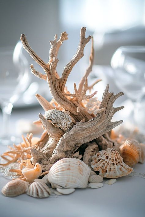 Embrace the natural allure of beach wedding ideas with themes that capture the essence of simplicity and elegance. Imagine decor that enhances your ceremony with the sound of waves as your backdrop. Whether it's a small gathering or a grand reception, the coastal aesthetics add a touch of magic, ensuring every dress and detail shines in the beach's soft glow. Upscale Beach Wedding, Driftwood Centerpiece Ideas, Fish Themed Wedding, Coastal Themed Wedding, Beachy Wedding Centerpieces, Beach Wedding Aesthetic Decor, Driftwood Wedding Decor, Ocean Wedding Decor, Wedding Nature Theme