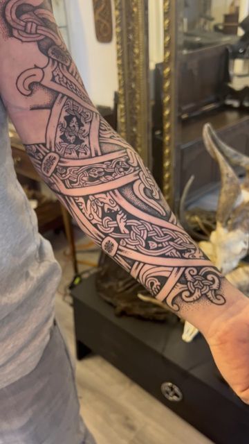 Sean Parry on Instagram: "Will’s Nordic/Celtic coverup. Work in progress. Will requested a mix of Nordic and Celtic, so the knotwork panels alternate between the two cultural styles. The panels are all the parts of the body of a single creature whose head is seen at the top of Will’s arm, framing and covering his old tattoo. Over the centre of the old design I’ve put a white bindrune, this isn’t so visible right now with all the black ink smudged over it, but it won’t affect how it comes out. Celtic Style Tattoo, Dagda Celtic God Tattoo, Nordic Pattern Tattoo, Nordic Forearm Tattoo, Norse Knotwork Tattoo, Runes Tattoos, Nordic Sleeve, Knotwork Tattoo, Druid Tattoo