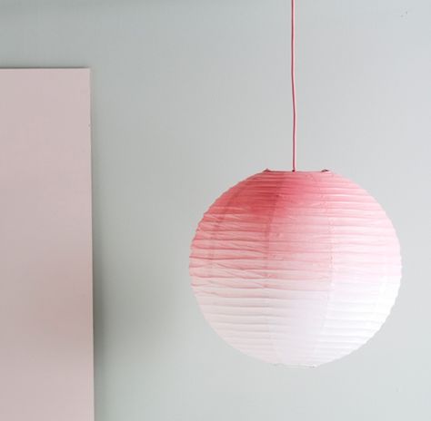 Recreate the look by saturating the top of the lamp with spray paint and allowing the paint to disperse, fading to white. Repeat for the desired effect and finish by spraying the pendant cord pink Ikea Bissa, Paper Lamp Shade, Mommo Design, Orb Light, Interior Props, Diy Hanging Shelves, Diy Ombre, Diy Shades, Ombre Pink