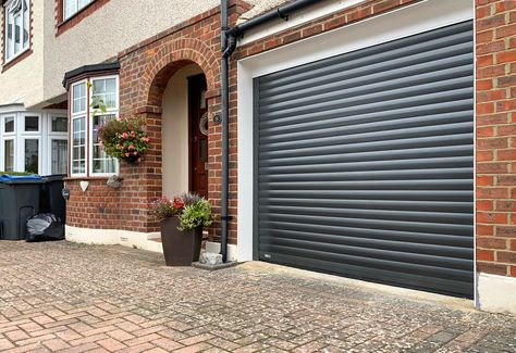 SWS SeceuroGlide Original Insulated Roller Garage Door Finished in Graphite Grey & Installed in Chessington By Our New Malden Branch. We fit all types of Garage Doors including both Retractable and Sectional Garage Doors. Call 0800 716 569 to speak with one of our experts or alternatively, visit www.accessgaragedoors.com to book a free survey. #AccessGD #SWS #rollergaragedoor #newmalden Roller Shutter Garage Doors, Roller Garage Doors, Grey Garage Doors, Bike Storage Garage, Sectional Garage Doors, Bungalow Style House, Modern Gate, Garage Conversion, Roller Shutters