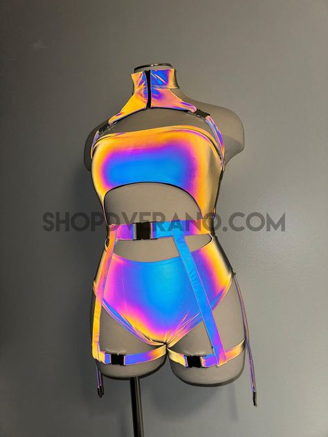 Please send us a message with any questions or deadlines!Introducing our new Flash Reflective Rave Bodysuit with Buckles - the perfect festival suit to elevate your party game. Made from high-quality Reflective Spandex material, this rave suit is designed to hug your curves in all the right places while ensuring breathability for hours of dancing and partying. It comes in a complete set, including unique bodysuit with straps down the sides, and garter buckles to add the perfect touch. This festi Germany Fits, Rave Suits, Unique Bodysuit, Plus Size Rave, Bodysuit Plus Size, Rave Bodysuit, Outfit Rave, Rave Clothing, Rave Outfit