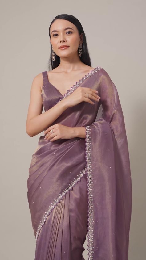 Indulge in the allure of this Orchid Glass Crush Saree. The mirror and stone embellishments on the scallop border create a rich tapestry of craftsmanship. The vibrant purple and lavender hues elevate the softness of the fabric, making it a statement piece for celebratory occasions. With detailed precision and an included unstitched blouse fabric, this saree assures a tailored fit. Lavender Designer Saree, Pastel Saree Aesthetic, Simple Sarees Party Wear, Best Sari Designs, Rich Saree Look, New Trending Saree Designs, Sarees Trending Latest, Designer Georgette Sarees Party Wear, Girlish Sarees Party Wear