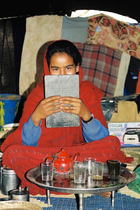 Mauritanian nomad girl wearing red robes making tea. Mauritanian Culture, Arabic Goddess, Kel Tamasheq, African Photography, Making Tea, The Sahara Desert, Sahara Desert, How To Make Tea, Culture Travel