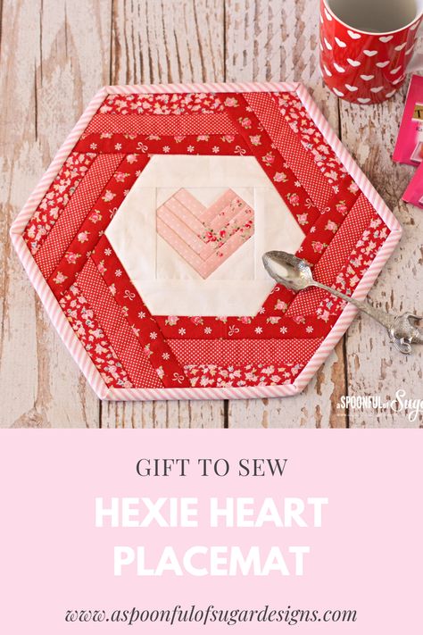 Hexie Heart placemats can be made to coordinate with your table and are easily constructed in an afternoon. Using a foundation paper piecing method, you will quickly and accurately make the inner hexagonal heart block. Simple patchwork borders are the finishing touch. This is a quick project that can be used as a placemat, mug rug, trivet or pot holder. Heart Placemats, Small Quilt Projects, A Spoonful Of Sugar, Christmas Is Over, Valentine Projects, Mini Charm, Foundation Paper Piecing, Small Quilts, Mug Rug