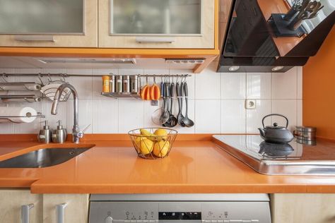 Premium Photo | Kitchen with cream wood cabinets paired with orange countertops and orange accents throughout Pastel Orange Kitchen Cabinets, Orange Oven Kitchen, Orange Countertops, Orange Kitchen Cabinets Modern, Orange Kitchen Cabinets, Orange Splash Back Kitchen, 70s Orange Kitchen, Photo Kitchen, Orange Kitchen