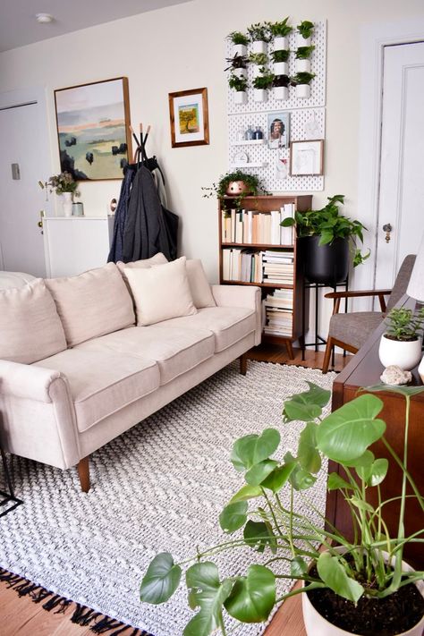 This tiny studio apartment has a smart layout that easily separates the bedroom from the living area and the dining area. We love the DIY plant wall and the table in the entryway. Tiny Living Room Layout, Tiny Apartment Living Room, Tiny Living Room, Small Studio Apartment Decorating, Tiny Studio Apartments, Herb Wall, Apartment Needs, Studio Apt, Small Studio Apartment