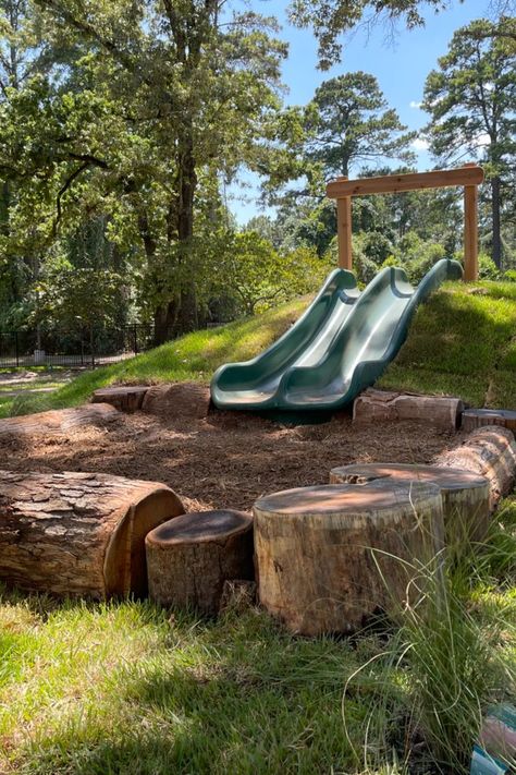 A double hill-slide on a natural playground. In Ground Slide On Hill, Hill Slide Diy, Slide In Hill Backyard, Diy Natural Playground Ideas, Log Playground Ideas, Slide In Hill, Nature Playground Ideas, Diy Hill Slide, Natural Playground Backyard