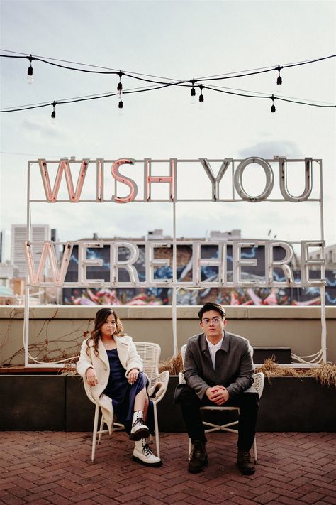 An engaged couple sit in chairs in a serious manner on a rooftop in downtown Denver at the Ramble Hotel in front of their 'Wish You Were Here' sign. Ramble Hotel, Cool Wedding Photos, Denver Engagement Photos, Colorado Wedding Elopement, Cool Wedding, Colorado Adventures, Colorado Engagement, Outdoor Wedding Photos, Colorado Elopement