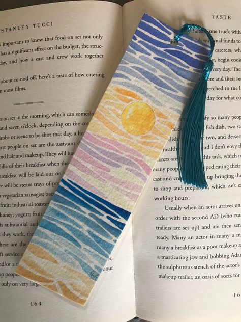 Original sunset watercolour bookmark, laminated and finished with a blue tassel. This is a stunning bookmark to compliment any book. Quality tassels. A beautiful present. Gouache Bookmarks Ideas, Toothless Bookmark, Watercolour Bookmark Ideas, Diy Bookmark Tassel, Watercolour Bookmarks Easy, Book Mark Art, Paint Chip Bookmarks, Sunset Bookmark, Bookmark Inspiration