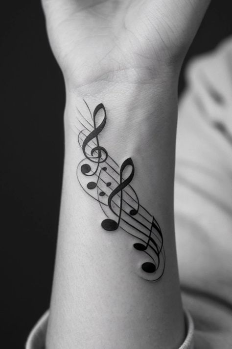 Musical notes and treble clef tattooed on a person's forearm. Musical Notes Tattoo Ideas, Music Back Tattoo, Simple Music Note Tattoo, Musical Note Tattoos For Women, Small Tattoo Ideas Music, Music Hand Tattoo, Music Tattoo Designs For Guys, Tattoo Ideas Female Music, Music Sleeve Tattoo Women