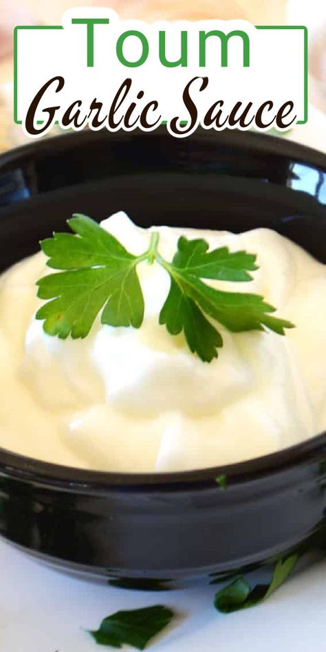 A single black bowl with white creamy sauce and a parsley leaf garnish with Pinterest overlay. Middle Eastern Garlic Sauce, Mediterranean Garlic Dip, Lebanese Garlic Dip, Toom Garlic Dip Recipes, Toom Garlic Dip, Toum Garlic Sauce, Toum Recipe, Garlic Dip Recipes, Egyptian Recipes