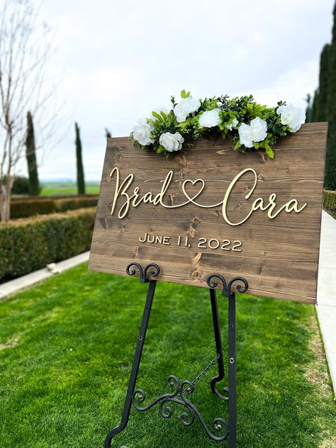 "This beautiful wood Wedding Sign is an eye-catcher for your guests to see as they enter your wedding venue!  The Wedding Welcome Sign is great to use as special wedding decor and can double as home decor after the wedding festivities end.  Our customers love to give these custom signs as wedding gifts, engagement gifts, and anniversary gifts as well since they make great gifts for couples.   The sign pictured is our 20x30 size, but we offer many sizes to suit your needs. Your sign will be personalized with 3-D lettering (laser cut) to welcome your guests to your special day and there are 4 stain options and 4 lettering color options to choose from.  Specifications for Wedding Signs: Solid Pine Wood\" ¾\" thick Walnut Stain (medium walnut), Dark Walnut, Gray Wash Stain, and Black 3-D (rais Welcome To Our Wedding Wood Sign, Wood Wedding Ideas Decor, Wedding Signs For Reception Wood, Entry Sign Wedding, Wedding Greeting Sign, Easels For Weddings Display, Wedding Yard Signs, Diy Welcome Sign Wood Wedding, Diy Welcome Wedding Sign Entrance