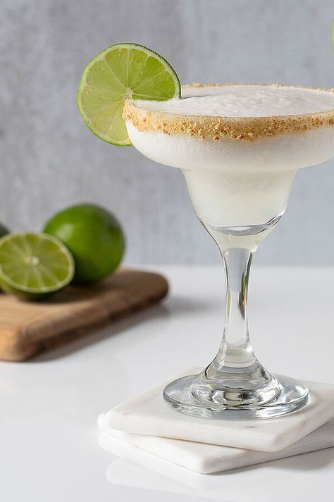 This frozen margarita was inspired by the flavors of a cool and creamy Key lime pie. Whip up a batch of these easy frozen margaritas for Cinco de Mayo or anytime you want a sweet and refreshingly tart treat! #healthydrinks #lowsugardrinks #drinkrecipes #drinkideas #healthyrecipes Key Lime Daiquiri, Key Lime Margarita Recipe Texas Roadhouse, Texas Roadhouse Key Lime Margarita Recipe, Key Lime Pie Margarita Recipe, Key Lime Pie Margarita, Key Lime Pie Drink Alcohol, Key Lime Pie Aesthetic, Key Lime Margarita Recipe, Creamy Key Lime Pie