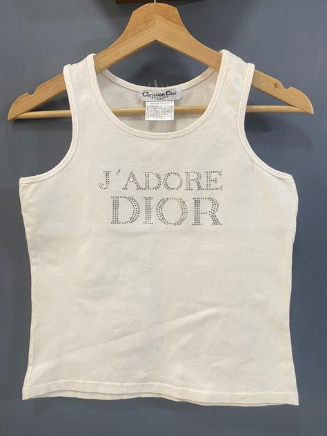 VINTAGE J'adore Dior Christian Dior rhinestone tank top ❤️DETAILS❤️Brand : Christian Dior 💥Material :95%cotton :5% Lycra 💥Colour : white 💥Madi in FRANCEsize :  Armpit to Armpit =15.5inch Length = 19 inch CONDITION : ( good vintage condition) NO RETURN / NO SWAP .OFFER ME YOUR BEST PRICE.  ✈️Shipping Item will be ship in 3 working days after purchase. It will take 3-5 working days to reach at destination. We are using DHL Express with tracking number.   💰Offer If you make offer, be prepare th Dior Monogram Outfit, Jadore Dior Tank Top, Jadore Dior Tshirt, Dior Tank Top, Vintage Tanks, Dior Clothes, J Adore Dior, Rhinestone Tank Top, Dior T Shirt