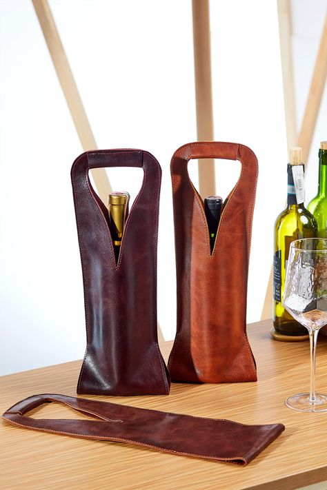 "A bag for one bottle is made from quality and nice to touch leather. Carefully sewn from one single piece of leather. This adds uniqueness and exquisite shape. Suitable for most bottles of different sizes - for sparkling wine, and for unusual-shaped, exotic drinks as well. But for standard bottles of wine it fits perfectly. We have strengthened the handle with additional layers of leather to feel confident when carrying it. Also this will allow to keep the shape of the bag with a smooth waist a Slim Aesthetic, Leather Wine Tote, Leather Wine Carrier, Crea Cuir, Diy En Cuir, Wine Caddy, Leather Craft Projects, Wine Bottle Bag, Whiskey Gifts