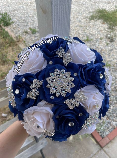 An elegant and beautiful bouquet! Customize bouquets are also available if needed. Different colors and brooches. 10inches in diameter You are welcome to message me and I will reply quick :) Hablo español 😊 Royal Blue And Gold Quince Bouquet, Dark Blue 15 Decorations, Quinceanera Flower Bouquet Blue, Royal Blue Ramo Quince, Royal Blue Bouquet Quinceanera, Blue And Silver Quinceanera Ideas, Dark Blue Quinceanera, Royal Blue And Silver Quinceanera, Royal Blue Quinceanera Ideas