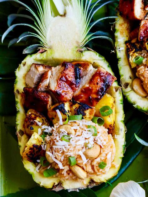 Grill Hawaiian Huli Huli Chicken, pineapple, and add some coconut lime rice into pineapple bowls. A gorgeous way to entertain for luaus, graduation celebrations, pool parties, or summer cookouts. On the islands of Hawaii, people line up at roadside stands, to order "plates" as whole chickens are slowly turning over hot mesquite wood coals. You will find families grilling this dish for gatherings, and it is served at fundraisers and community events like hulas. Stuffed Pineapple Bowls Chicken, Dinner Guests Recipes, Tahitian Food, Hawaiian Huli Huli Chicken, Hawaii People, Pineapple Bowls, Coconut Lime Rice, Hawaiian Plate Lunch, Hawaiian Foods