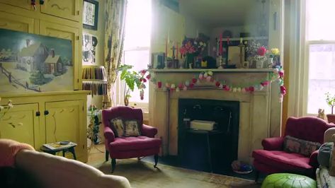 Amy Sedaris Apartment, Greenwich Apartment, Eccentric Living Room, Cream Chest Of Drawers, Yellow Cupboards, Leather Poof, Greenwich Village Apartment, White Rocking Chairs, Eccentric Decor