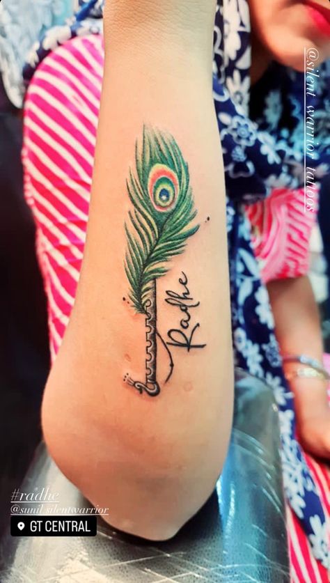 Visit silent warrior tattoos #jaipur to get inked. #peacockfeather #tattoo #colorful #flute #radhe #tattooidead #fashion #tattoodesign #tattooart Radhe Radhe Tattoo Design, Flute With Feather Tattoo Designs, Radhe Radhe Tattoo, Radhe Krishna Tattoo, Peacock Feather With Flute, Silent Warrior, Flute Tattoo, Tattoo Colorful, Krishna Tattoo