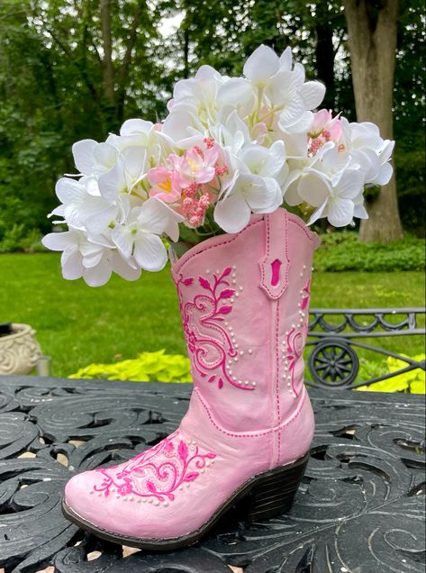 A pink cowboy boot vase with flowers in it Cowboy Boot Vase With Flowers, Cowgirl Boot Vase, Cowboy Boot Flower Vase, Cowboy Boot Ceramic, Fun Cowboy Boots, Pink Western Decor, Ceramic Cowboy Boot, Cowboy Boot Decor, Cowboy Boot Flowers