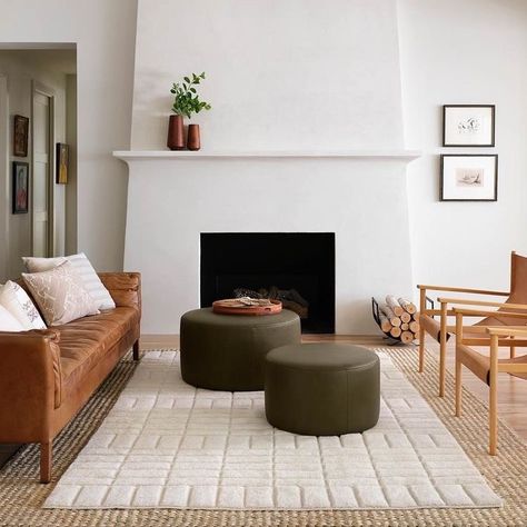 Ottomans have seen a big increase in popularity in recent years, and for good reason. An ottoman is an extremely versatile piece and does… | Instagram Minimal Fireplace, Large Leather Ottoman, Plaster Fireplace, White Stone Fireplaces, Modern Fireplace Mantels, Built In Around Fireplace, Home Design Store, Fireplace Tv Wall, The Citizenry