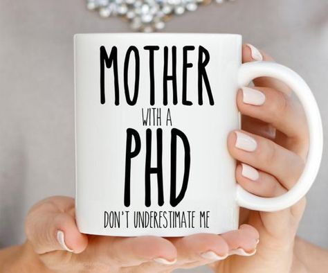 Graduation Gift Mother with PHD Coffee Mug<> Design is on Both Sides of this cup<> Printed using the highest quality inks, which will not fade, rub, or peel away<> Choose an 11 oz or a big 15 oz Mug with comfy handle <> Dishwasher and Microwave Safe© 2020 Crate68All content, designs, and product pictures contained within YaGottaLoveIt Designs listings are the intellectual property of Crate68 Designs Mother of the Groom Gift from Brideand are not to be copied, reproduced, Funny Boyfriend Gifts, Phd Gifts, Law School Inspiration, Mother Of The Groom Gift, Mother Of The Groom Gifts, Funny Cups, Funny Mom Gifts, Printed Cups, Boyfriend Anniversary Gifts