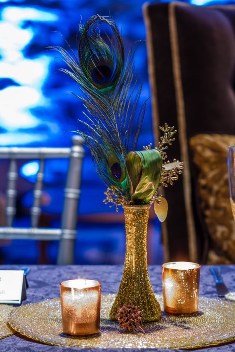 Peacock Feather with Gold Vase Centerpiece, perhaps add more white flowers -- baby breath, roses, lilies, etc. Peacock Feather Wedding Centerpieces, Peacock Table Decorations, Art Deco Table Centerpieces, Peacock Centerpieces Table Decorations, Peacock Decorating Ideas, Peacock Feather Centerpieces, Peacock Theme Decoration, Peacock Party Theme, Peacock Wedding Centerpieces