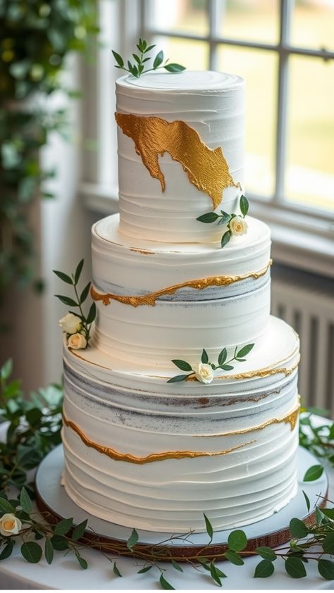 Three-tier white wedding cake with gold brushstroke accents and green leaves. Wedding Cake Gold Leaf, Wedding Cake Designs Elegant, White And Gold Wedding Cake, Classic White Wedding, Cake Elegant, Wedding Cake Ideas, Pink Wedding Cake, White Frosting, Modern Wedding Cake