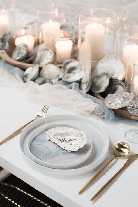 a neutral beach wedding tablescape with fabric runners, seashells, candles, watercolor porcelain and gold cutlery Beach Wedding Table Settings, Nautical Wedding Centerpieces, Nautical Wedding Favors, Beach Wedding Tables, Beach Wedding Decorations Reception, Romantic Beach Wedding, Nautical Wedding Theme, Beach Wedding Reception, Wedding Tablescape