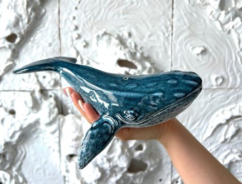 Humpback Whale Ceramic Sculpture is designed by Viktor Kushchenko the founder of KUST ceramics brand, each figurine is the handmade work with the help of molds, so every whale is unique and have its own soul. This stunning humpback whale ceramic figurine is not only a beautiful piece of decor but also makes for a thoughtful gift for any ocean lover. Handcrafted with exquisite detail, this figurine captures the grace and majesty of the magnificent humpback whale. Whether displayed on a mantel, sh Unique Pottery Sculpture, Whale Clay, Whale Figurine, Ceramic Whale, Ocean Home Decor, Sculpture Ceramic, Whale Art, Ceramic Figurine, Ceramics Pottery Art