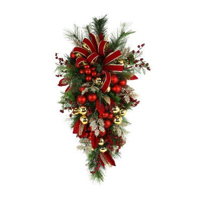 Add holiday cheer to your space with this festive swag. Adorned with red and gold ribbons, gold and red ornaments, red and gold leaves, and red berries, this holiday swag offers a classic take on Christmas decor. It can be used indoors or on a covered porch. | The Holiday Aisle® Holiday Swag w/ Berries, Feathers, Ornaments And Ribbon Brown/pink/Red 35.0 x 22.0 x 10.0 in, Polysilk | C009144765 | Wayfair Canada Christmas Swags For Staircase, Christmas Teardrop Wreath, Red And Gold Christmas Decorations, Brown And Red Christmas Decor, Christmas Teardrop Swags, Christmas Swags For Front Door, Christmas Swags Ideas, Swags And Wreaths, Elegant Wreaths