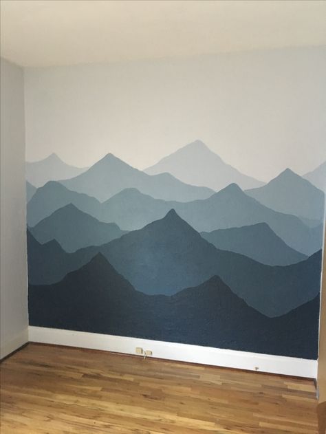 Painted a mountain mural in our nursery! Used sherwin Williams Rock Candy and Sea Serpent. So happy with how it turned out! Mountainscape Wall Mural, Mountain Nursery Diy, Wall Paint Mountains, Blue Wall Mural Ideas, Blue Mountain Mural, Mountain Themed Office, Mountain Themed Bathroom, Mountains Wall Painting, Painting Mountains On Wall