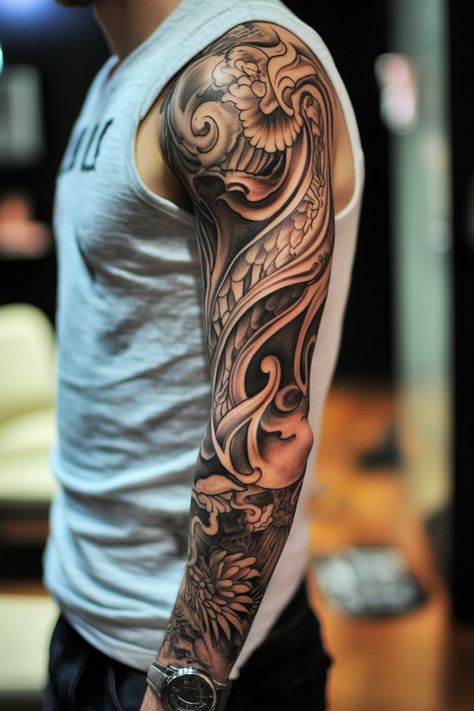 Person with a detailed and intricate full sleeve tattoo showing artistic patterns on their arm. Manly Sleeve Tattoos, Men’s Sleeve Tattoo, Half Sleeve Tattoos For Men Upper Arm, Sleeve Tattoos Men, Mens Sleeve Tattoo, Sleeve Tattoos Ideas, Tree Sleeve, Sleeve Tattoos For Guys, Black And Grey Sleeve