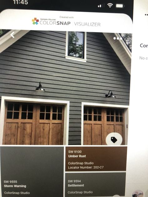 Deep River Paint Color With Walnut Garage Door, Dark Gray Hardy Board Siding, Garage Door Colors With Urban Bronze Paint, Gray House Brown Garage Door, Dark Gray Mountain House Exterior, Navy House Exterior, Dark Grey Houses, Exterior Gray Paint, Outside House Colors