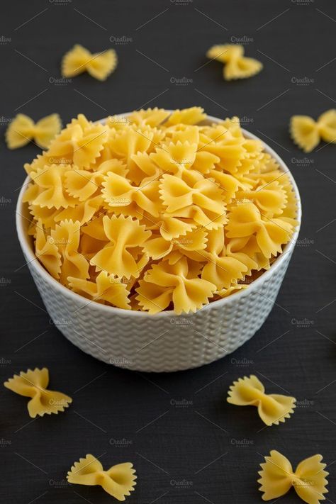 Raw Organic Farfalle Pasta in a Bowl on a black background, low Pasta In A Bowl, Pasta Farfalle, Farfalle Pasta, Black Bowl, Low Angle, Background Black, A Bowl, Black Background, Black Backgrounds