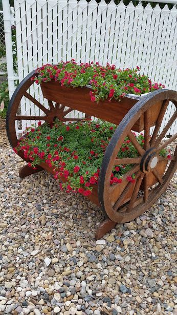 100+ Creative DIY Recycled Garden Planter Ideas To Try Today | HubPages Wagon Wheel Garden, Tin Flower Pots, Recycled Garden Planters, Garden Wagon, Plant Pot Diy, Garden Junk, Garden Decor Projects, Recycled Garden, Pallets Garden