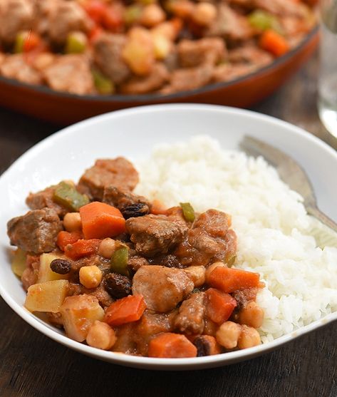 No party is complete without Pork Menudo! Chock-full of tender pork, garbanzo beans, vegetables, and raisins in a thick tomato sauce, this classic Filipino stew is hearty, tasty, and will easily feed a large crowd. Menudo Recipe Filipino, Filipino Menudo, Pork Menudo Recipe, Pork Menudo, Filipino Pork Recipes, Menudo Recipe, Pineapple Juice Recipes, Philippines Recipes, Filipino Dish