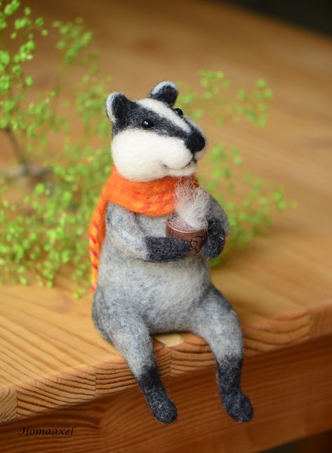 A small felt badger with an orange scarf sits on a shelf and drinks coffee. Small wool sculpture of a badger for a bookshelf. Felted Badger, Felt Badger, Wool Sculpture, Needle Felted Fox, Needle Felted Owl, Heidelberg Germany, Red Owl, Felt Fox, Small Owl