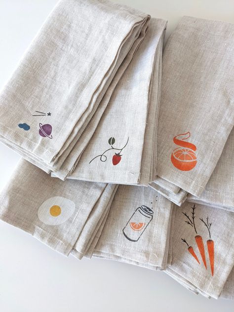 "These adorable linen napkins are hand stenciled with Jacquard textile paint. Manufactured in Northern California, Jacquard paints have been beloved by artists for decades. The paint is permanent, flexible, and never cracks or peels. Applying the paint by hand gives each stencil dimension and color variation; A true one of a kind piece. Add an egg, clementine, or even a bit of outer space to your dining table or gift a sweet lil Milk and Monstera to a friend. CARE Machine Wash Cold, Line Dry ABO Hand Painted Linen, Embroidery Napkins, Tea Towels Diy, Textile Paint, Linen Dinner Napkins, Diy Napkins, Hand Stencil, Fabric Stamping, Bag Display