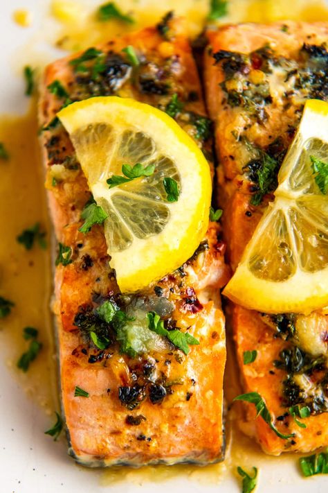 This tender and flaky baked lemon garlic salmon is a fancy weeknight meal ready in just 25 minutes. The fish is flavored with a buttery lemon garlic sauce and baked to juicy, flaky perfection! Lemon Garlic Salmon Baked, Garlic Lemon Salmon, Air Fryer Mahi Mahi, Honey Lemon Salmon, Easy Fish Taco Recipe, Best Fish Taco Recipe, Easy Fish Dinners, Baked Salmon Lemon, Lemon Butter Salmon