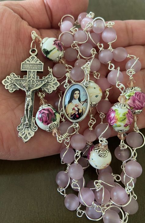 "This beautiful handmade rosary is made with 8mm cat's eye matte pink glass, 10mm ceramic beads and 2\" Pardon crucifix.   Length: 20\" inches long" Rosary Aesthetic, Beautiful Rosary, Handmade Rosary, Catholic Decor, Glow Jewelry, Inspire Bible Journaling, Cross Art, St Therese, Catholic Rosary